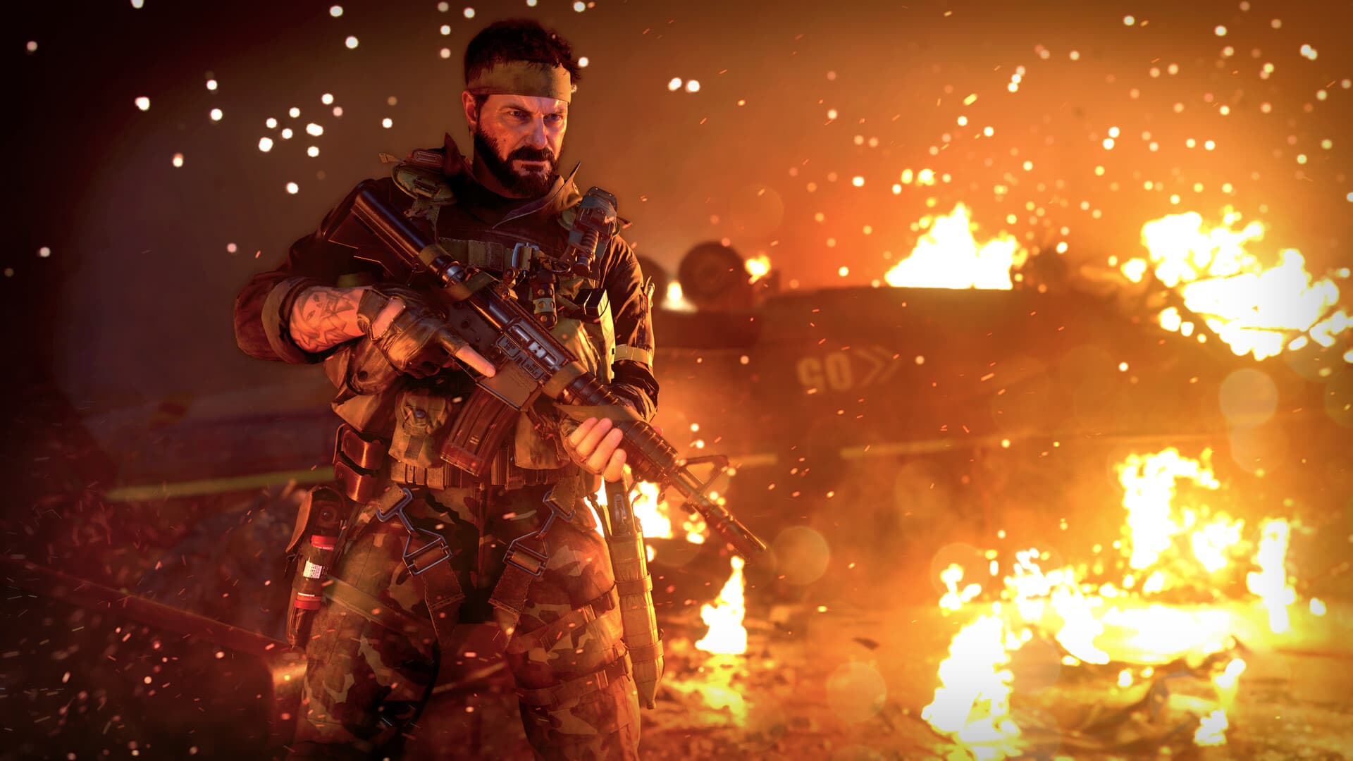 Call of Duty: Black Ops Cold War: a soldier with a rifle in front of a burning armoured vehicle