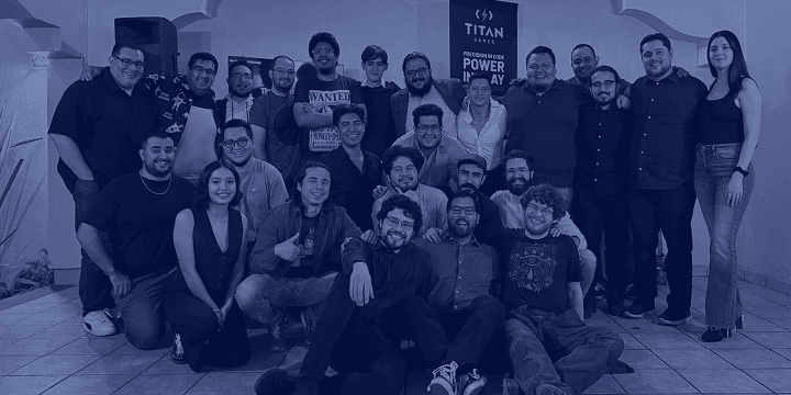 The TITAN Games team together in the studio, with the TITAN banner behind them